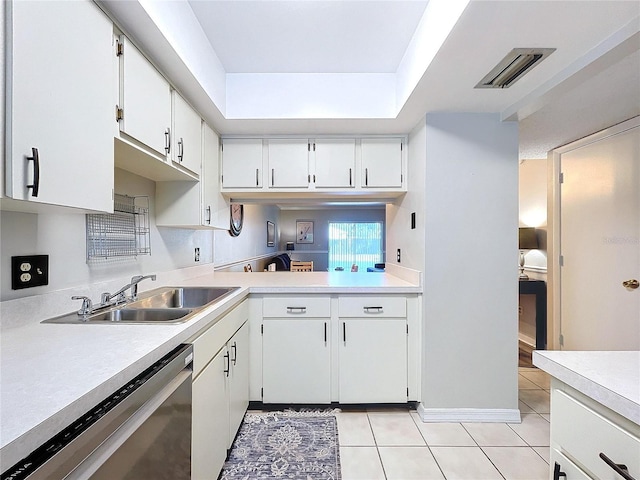 kitchen featuring light tile patterned flooring, sink, white cabinets, and stainless steel dishwasher