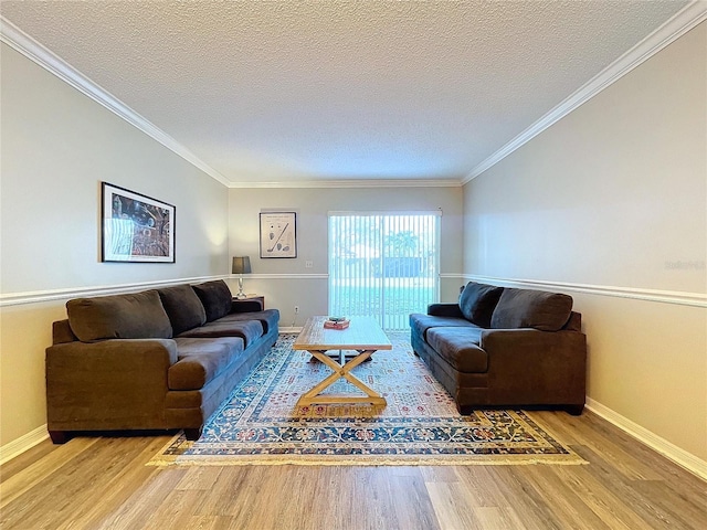 living room with hardwood / wood-style floors, a textured ceiling, and crown molding