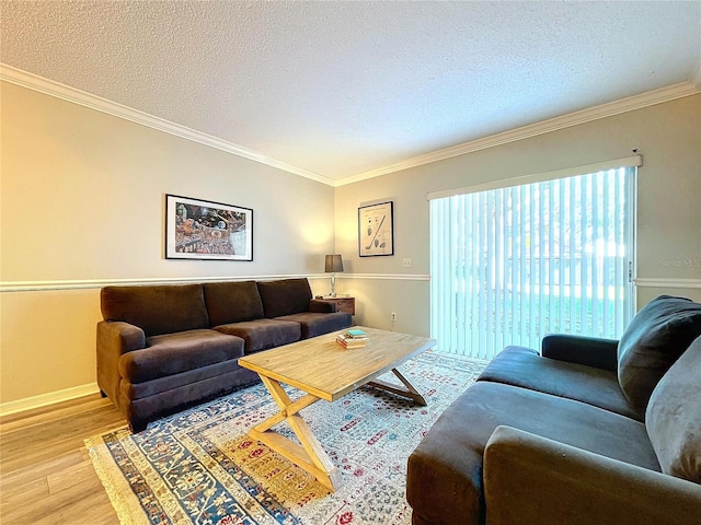 living room with a textured ceiling, light wood-type flooring, and crown molding