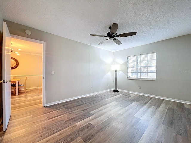 unfurnished room featuring ceiling fan, a textured ceiling, and light wood-type flooring