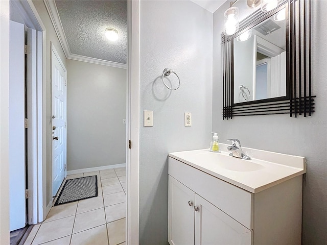 bathroom featuring crown molding, tile patterned flooring, vanity, and a textured ceiling