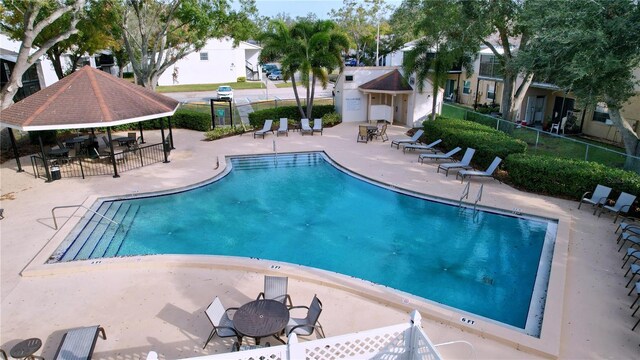 view of swimming pool with a gazebo and a patio