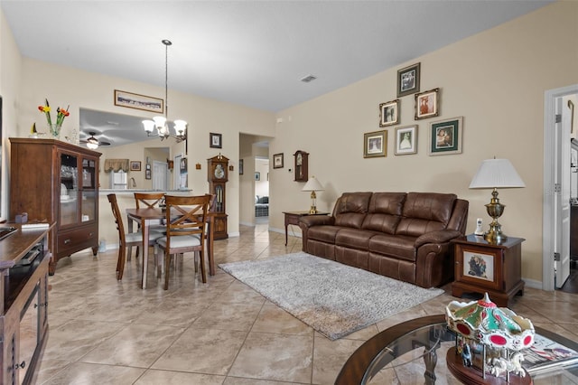 living room with a notable chandelier and light tile patterned floors