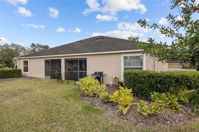 rear view of property with a yard