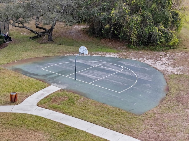 view of sport court with a yard