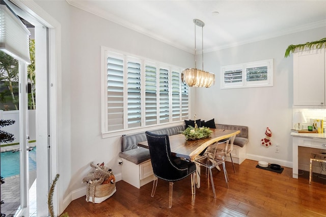 dining area with breakfast area, a healthy amount of sunlight, dark hardwood / wood-style floors, and a notable chandelier