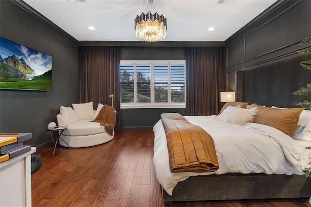 bedroom featuring a notable chandelier, dark hardwood / wood-style floors, and ornamental molding