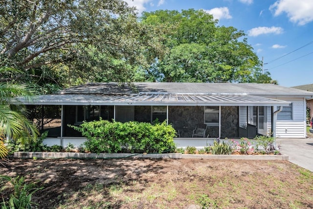 ranch-style house featuring a sunroom