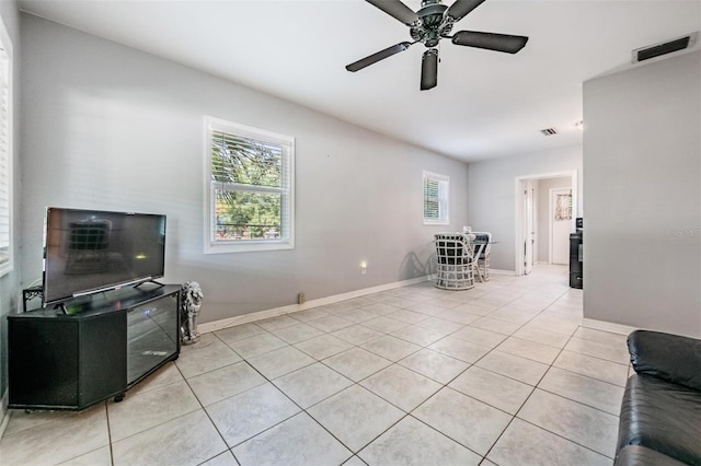 tiled living room featuring ceiling fan