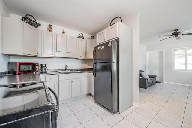 kitchen with black appliances, ceiling fan, white cabinets, and sink