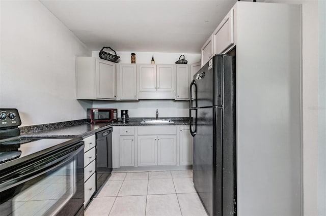 kitchen featuring light tile patterned floors, sink, white cabinetry, and black appliances