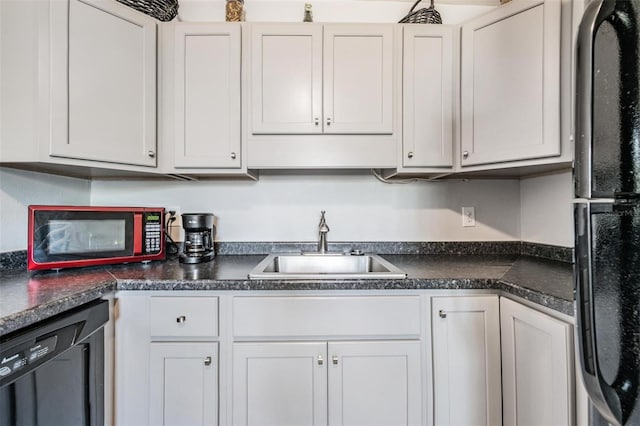 kitchen featuring sink, white cabinets, and black appliances