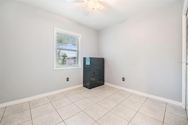 tiled empty room with ceiling fan