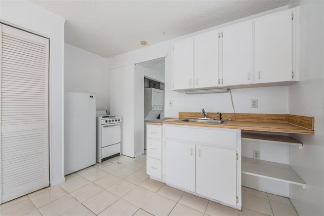 kitchen featuring a textured ceiling, white cabinetry, sink, and white appliances