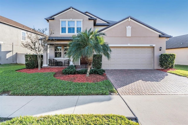 view of front of property featuring a front lawn and a garage