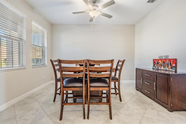 tiled dining area featuring ceiling fan