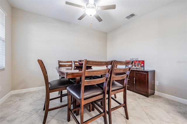 dining room with ceiling fan and light tile patterned flooring