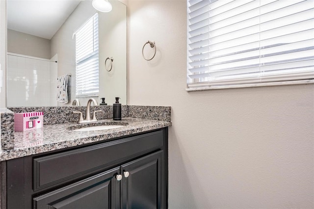 bathroom featuring vanity and a shower