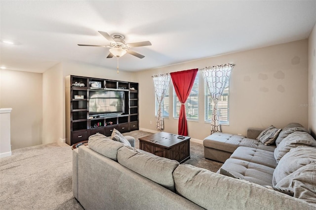 carpeted living room featuring ceiling fan