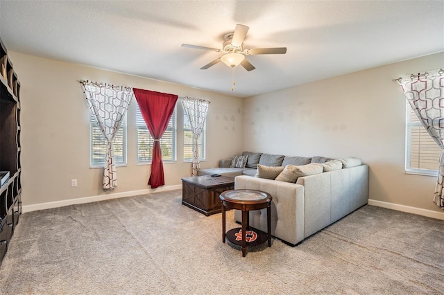 living room with ceiling fan and carpet