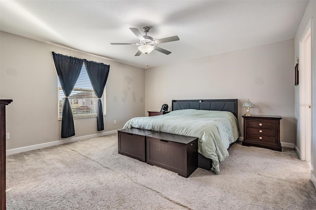 bedroom featuring ceiling fan and light carpet