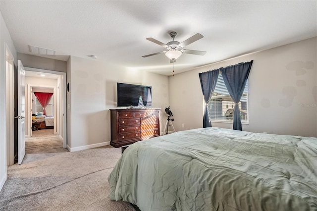 bedroom with ceiling fan and light carpet