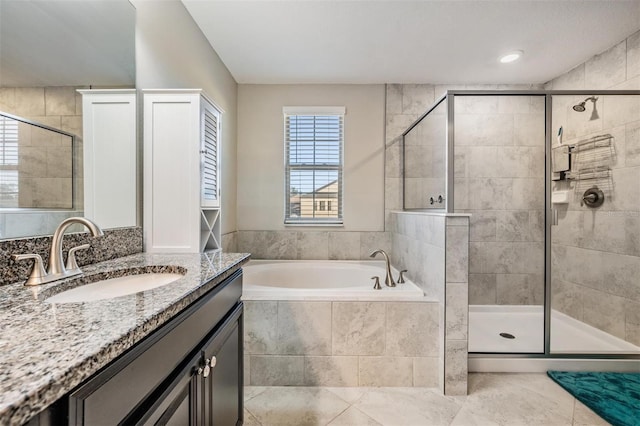 bathroom featuring tile patterned floors, vanity, and independent shower and bath