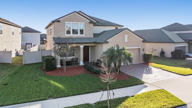 view of front of house with a garage and a front lawn