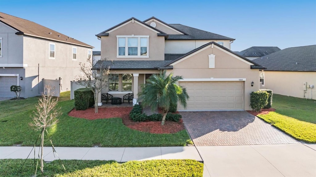30868 Kelmin Ter, Wesley Chapel, FL 33543 - view of front property featuring a garage and a front lawn