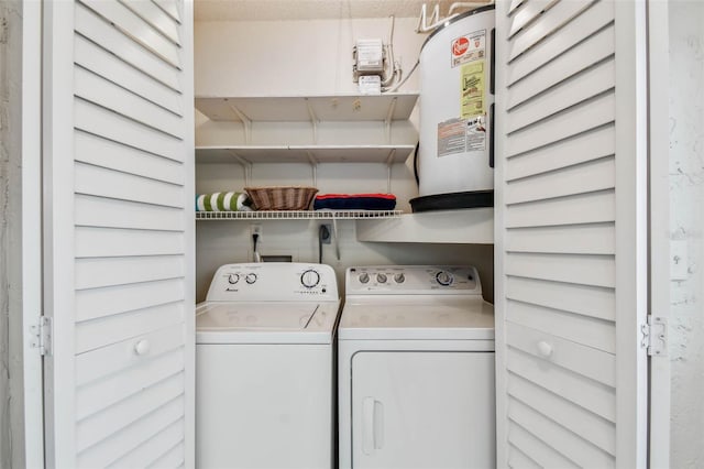 laundry area with water heater and washer and dryer