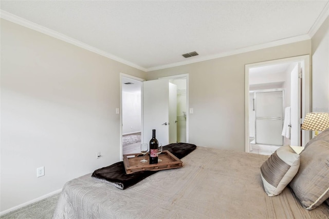 carpeted bedroom featuring a spacious closet, ensuite bathroom, a closet, and ornamental molding