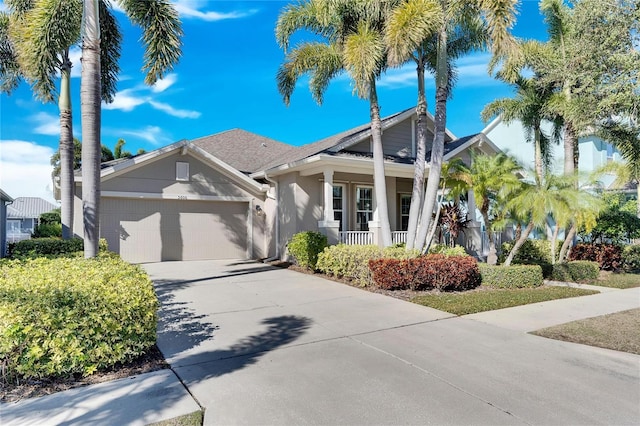 view of front of home featuring covered porch and a garage