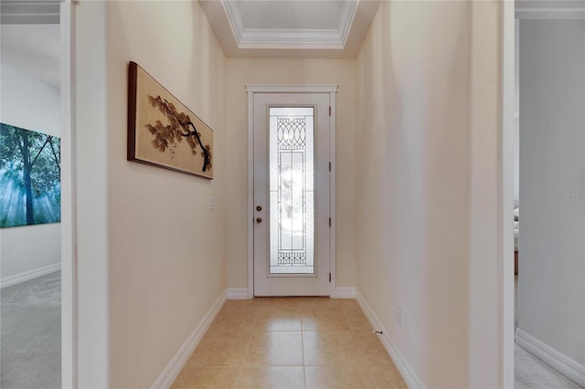 entrance foyer with crown molding, light tile patterned flooring, baseboards, and a tray ceiling