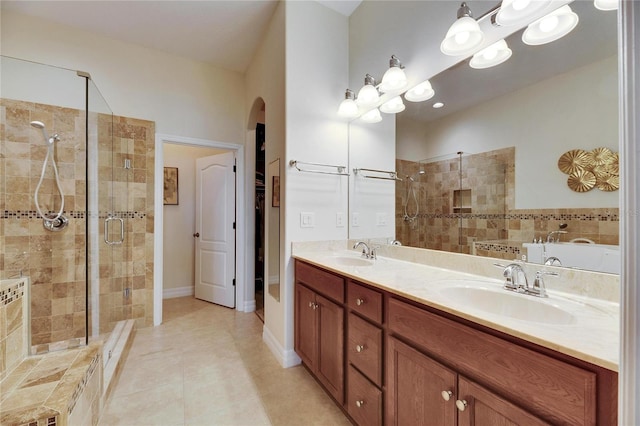 bathroom with tile patterned flooring, vanity, and a shower with door