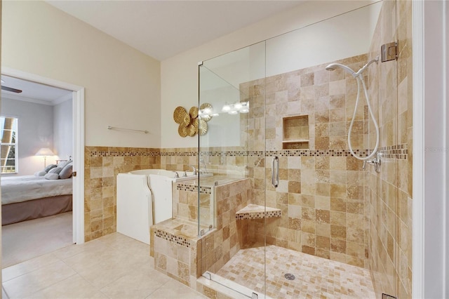 bathroom featuring tile patterned flooring, ornamental molding, tile walls, and walk in shower