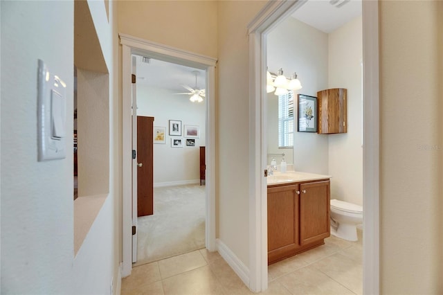 bathroom featuring tile patterned floors, ceiling fan, vanity, and toilet