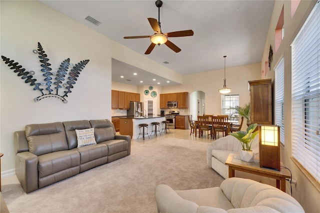 living room with ceiling fan and light carpet