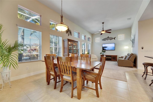 tiled dining area with ceiling fan