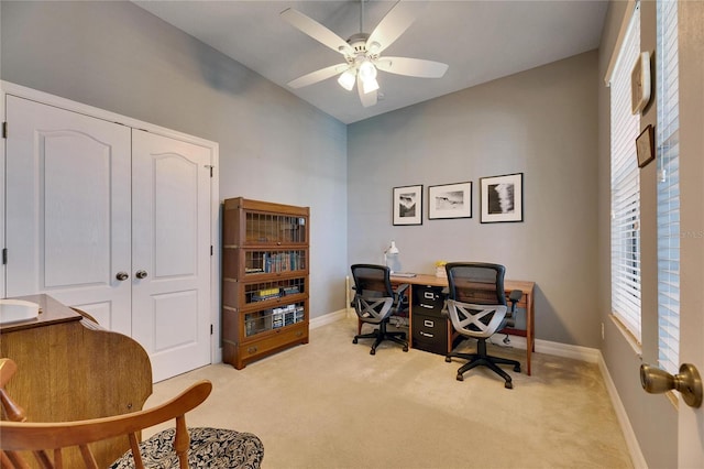 carpeted office space with ceiling fan