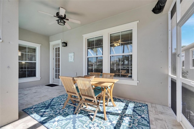 sunroom / solarium featuring ceiling fan