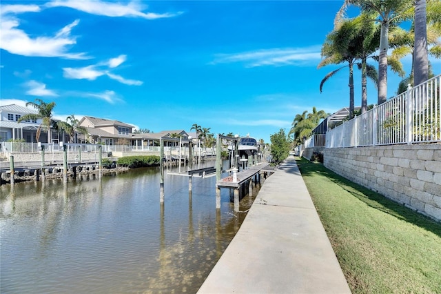 view of dock featuring a residential view, a water view, and boat lift