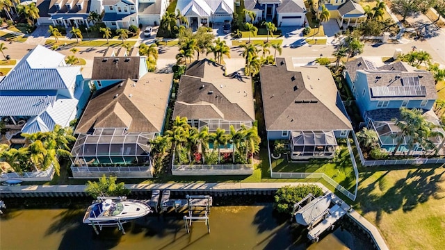 drone / aerial view featuring a residential view and a water view