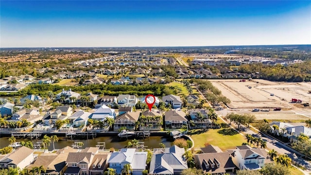 bird's eye view featuring a residential view and a water view