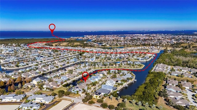 birds eye view of property featuring a water view and a residential view