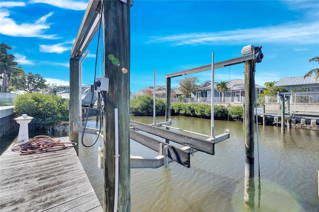 view of dock featuring a water view and boat lift