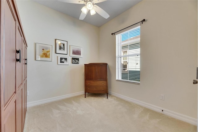 unfurnished room with light carpet, ceiling fan, and baseboards