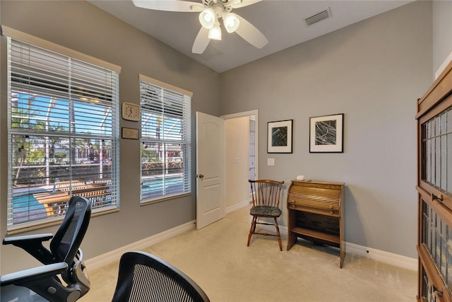 home office with visible vents, light carpet, and baseboards