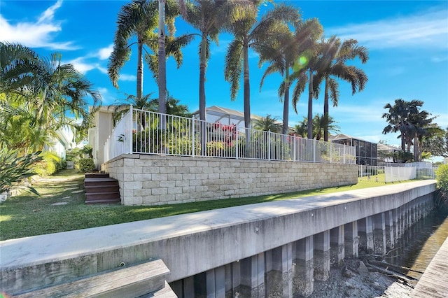 view of pool featuring a lawn and fence