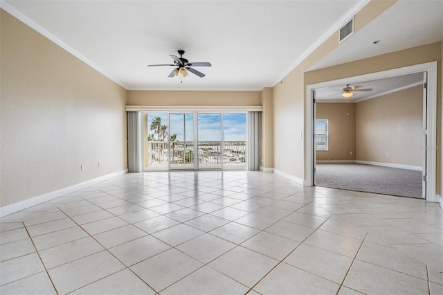 spare room featuring ceiling fan, light tile patterned floors, and crown molding