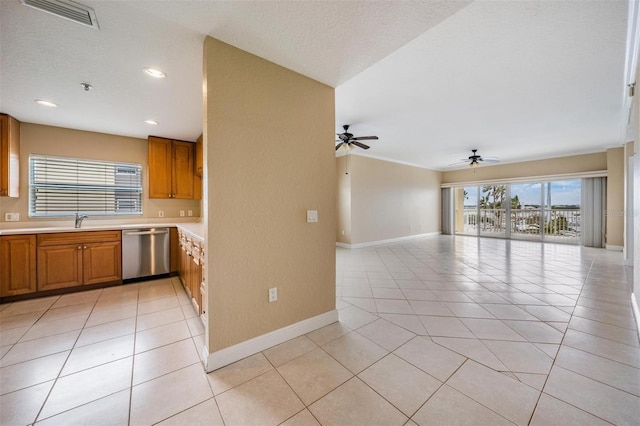 kitchen featuring ceiling fan, dishwasher, sink, a textured ceiling, and light tile patterned flooring